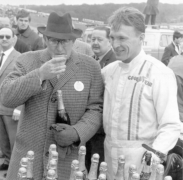 To the winners go the spoils: Dan wins 100 bottles of champagne at the Race of Champions, Brands Hatch 1967. Harry Weslake, Chairman of Weslake Engineering, takes the first and well-deserved sip. Photo: Courtesy Dan Gurney/All American Racers